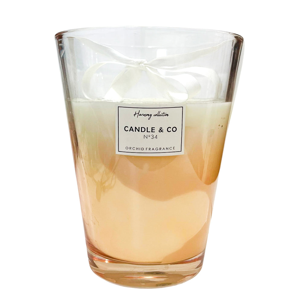 Vela aromática Home Deco Factory beige de 23 cm con vaso de vidrio.